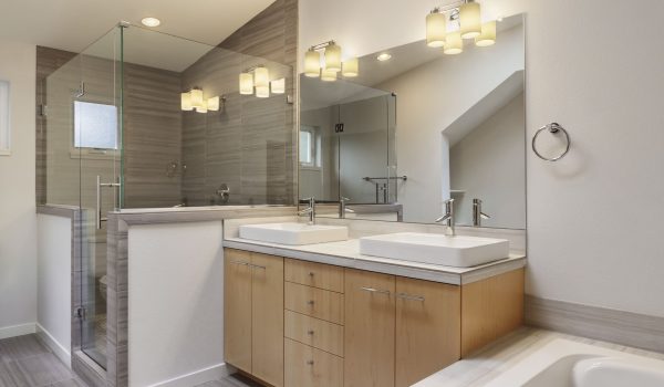 Ensuite Bathroom2 Modern ensuite bathroom featuring dual sinks, glass shower, wooden cabinetry, and stylish lighting fixtures. Pro Renovations